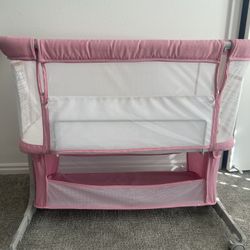 Pink baby bassinet