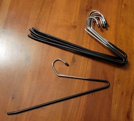 Set of 6 sturdy open-ended metal pants hangers with black non-slip coating and chrome hooks.

The open-ended design makes it easy to slide pants on an
