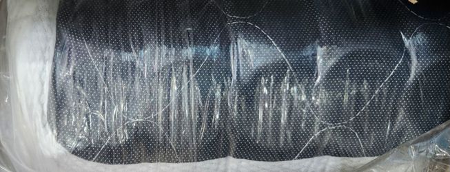 New black rolled-up queen size mattress