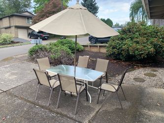 9-Piece Patio Dining Set – Table, 6 Chairs, Umbrella, Base & Rug – $150