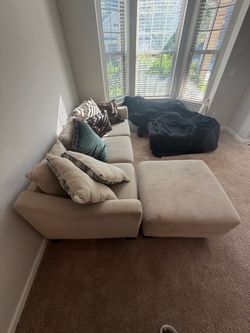 Cream colored couch and love seat.