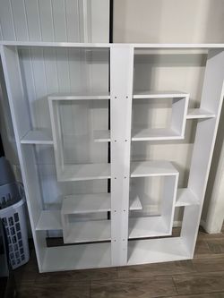 White geometric bookshelf (leaning)