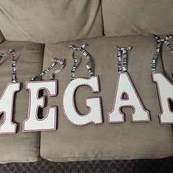 Brand new Hand painted custom-made letters that spell out “MEGAN”,