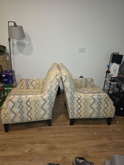 Upholstered arm chairs with geometric patterns.