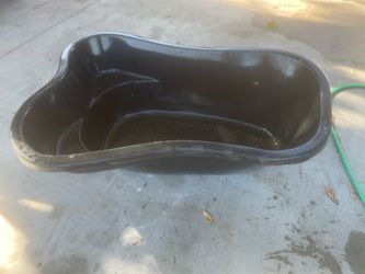 rigid preformed pond liner, possibly a 30-gallon or 60-gallon model