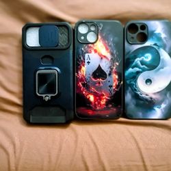 Selling a 3-case iPhone 14 Bundle. Rugged/ Heavy Duty Kickstand Case With Camera Slide, Ace Of Spades Fire Design Case, And Yin Yang Galaxy Artwork Ca