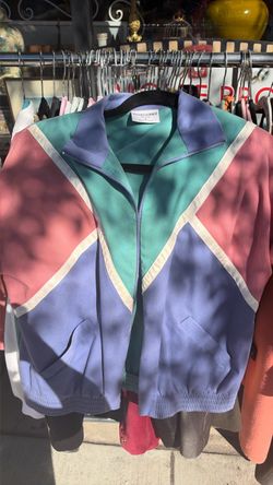 his is a vintage Alfred Dunner women's petite size 6 colorblock full-zip windbreaker jacket featuring a teal, purple, pink, and white geometric design