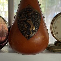 Antique/vintage 9 inch tall leather covered bottle metal topper and lion emblem with studs