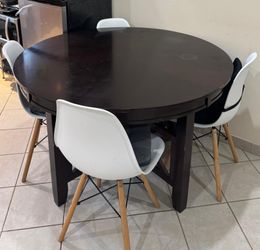 Round Dark Brown Dining Table with 4 White Eames Style Chairs