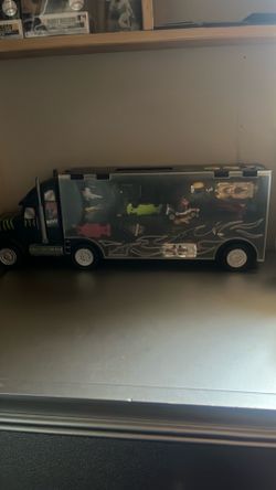 A bunch of hot wheels and storage truck for them
