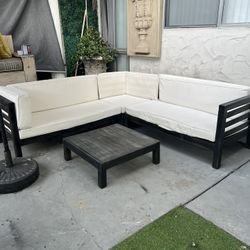 Beautiful wooden patio set; the cushions need covers.
