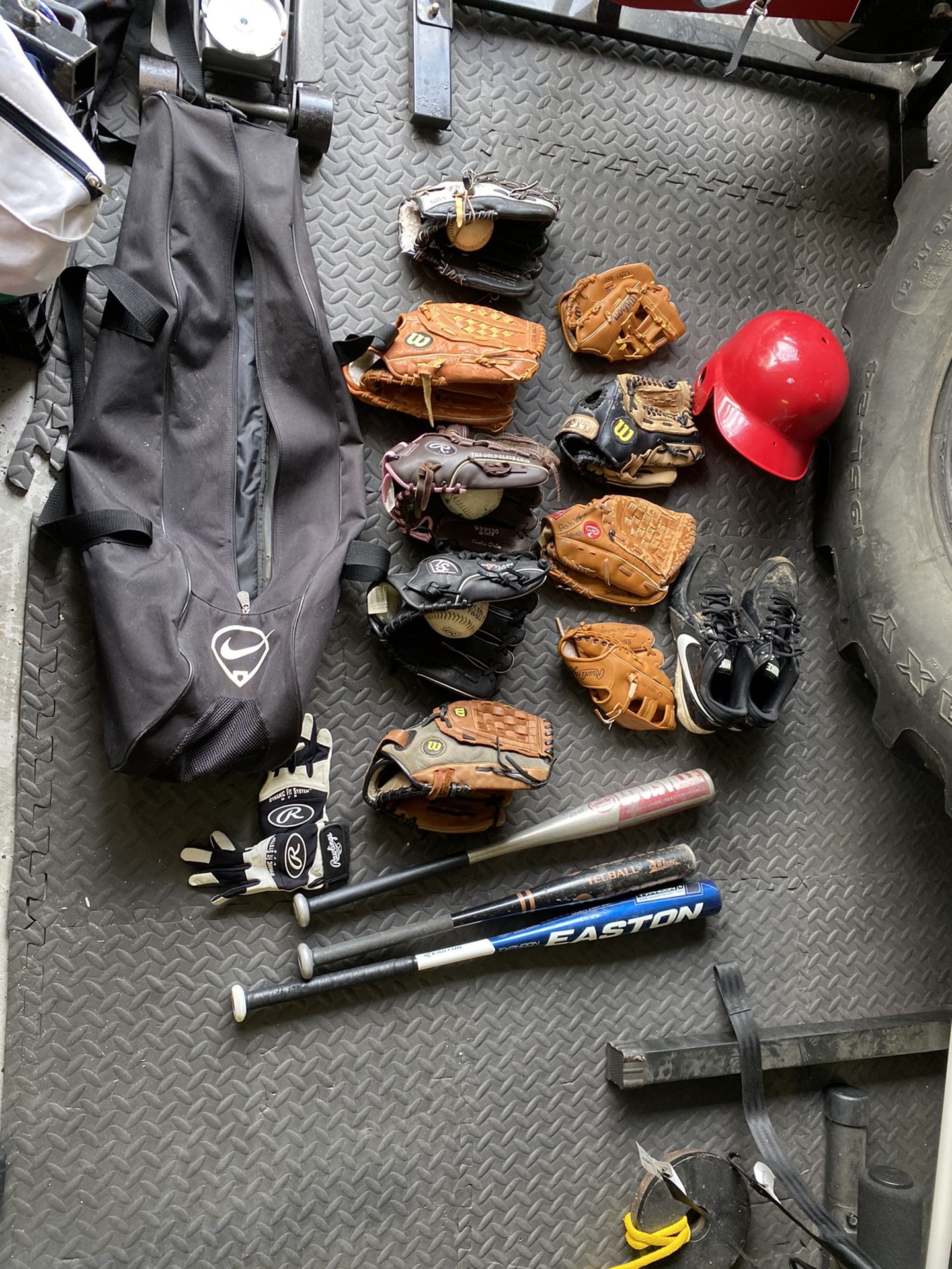 Baseball gloves, bats, cleats, and helmet