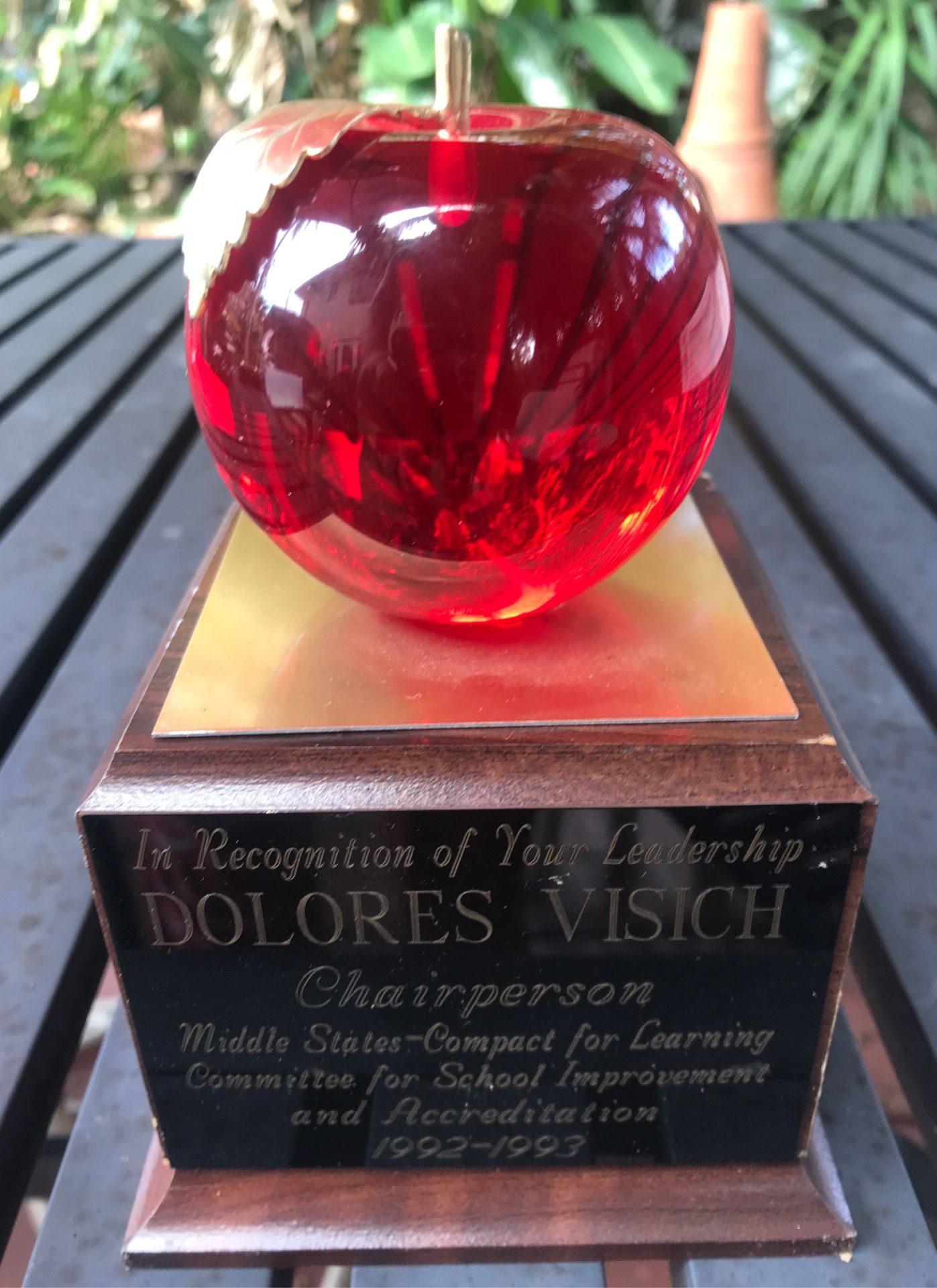 Glass apple award on wood base