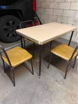 Small dining table with three chairs