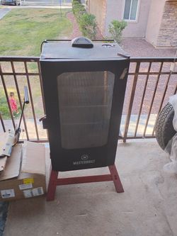 Masterbuilt 5 rack smoker electric black red and gray in color like new condition minus one or two dings on it