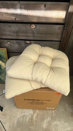 Two beige seat cushions