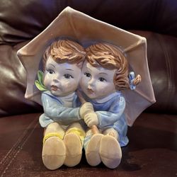 Figurine, boy & girl sitting holding umbrella