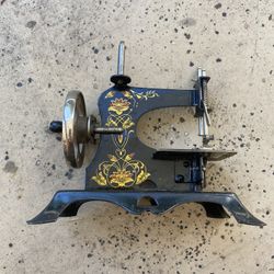 2- Antique Handheld Sewing Machine. 