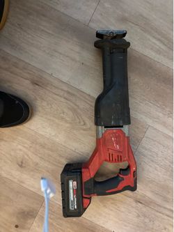 Milwaukee Red lithium high output battery, and Milwaukee ripsaw.