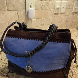 The SAK Blue and Brown Suede Purse w/Leather 8” Straps (11”W X 9”L) flower pattern inside with inside pockets and middle zipper pocket 