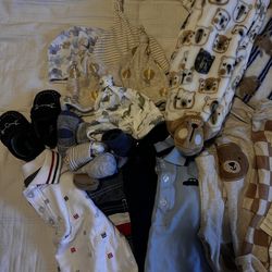 Baby boy clothes, blankets, socks, pair of shoes, beanies, and carrier