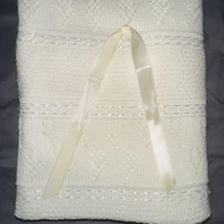 Brand new, never used  White/ivory knit baby blanket with lace ribbon border and ribbon detail