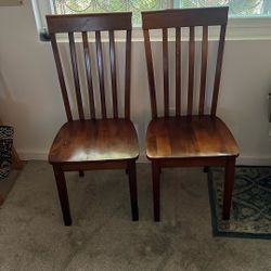 Two Dark Brown Wooden Chairs