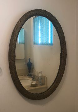 Oval gold lead mirror