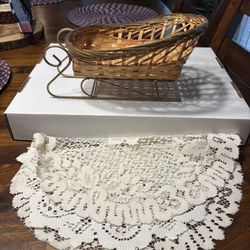 Wicker sleigh basket and white Doily 