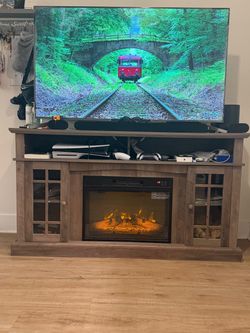 Wooden entertainment center with electric fireplace