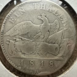 1818 Prussian Thaler coin featuring a crowned eagle over weapons on the reverse side.  