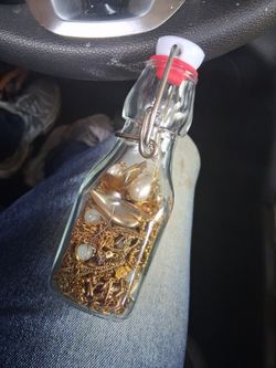 Small jar of broken gold jewelry
