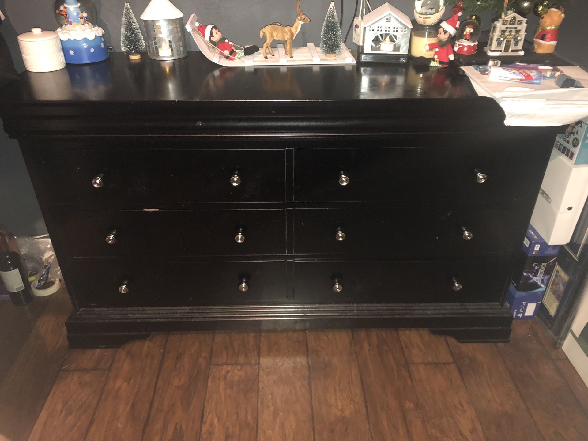 Black dresser with silver knobs. 6 drawers.