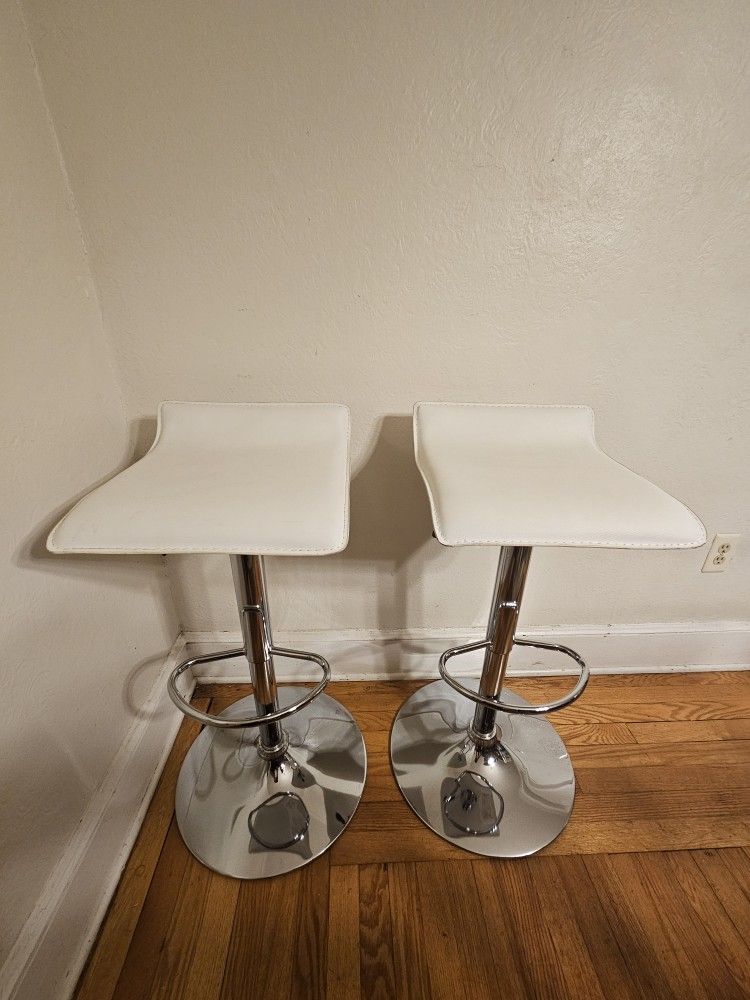 Pair Of White Faux Leather Adjustable Height Bar Stools With Chrome Base And Foot Rest