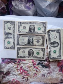 Star note dollar bill and 2 dollar bills .