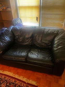 Black synthetic leather couch and loveseat