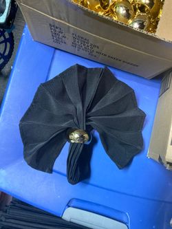 Gold napkin rings and black linen cloth napkins