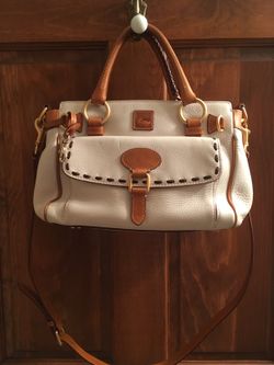 Authentic white with saddle brown leather trim Dooney and Bourke bag. Perfect condition no stains. $45