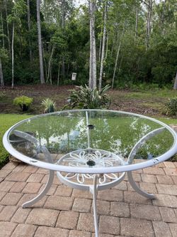 Patio Table  Glass Has A Chip In The Middle. Measures 28” H x 48”W 