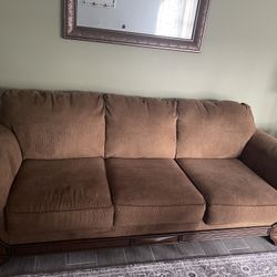 Matching Brown Couch With Wood Trim And Chair With Ottoman
