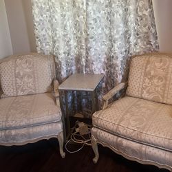 Louis XV style armchairs with cabriole legs and floral jacquard upholstery.