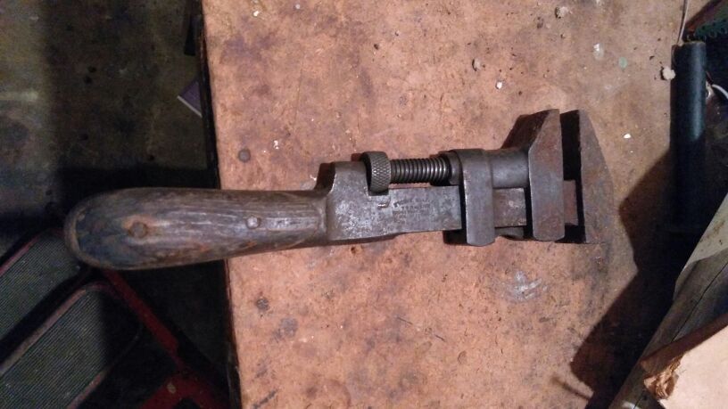 Old wrench with wooden handle