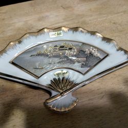 Fan Shaped With A 24K Gold Trim And A Depiction Of A Village Scene.