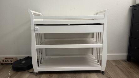 Baby white wood changing table with wheels and storage