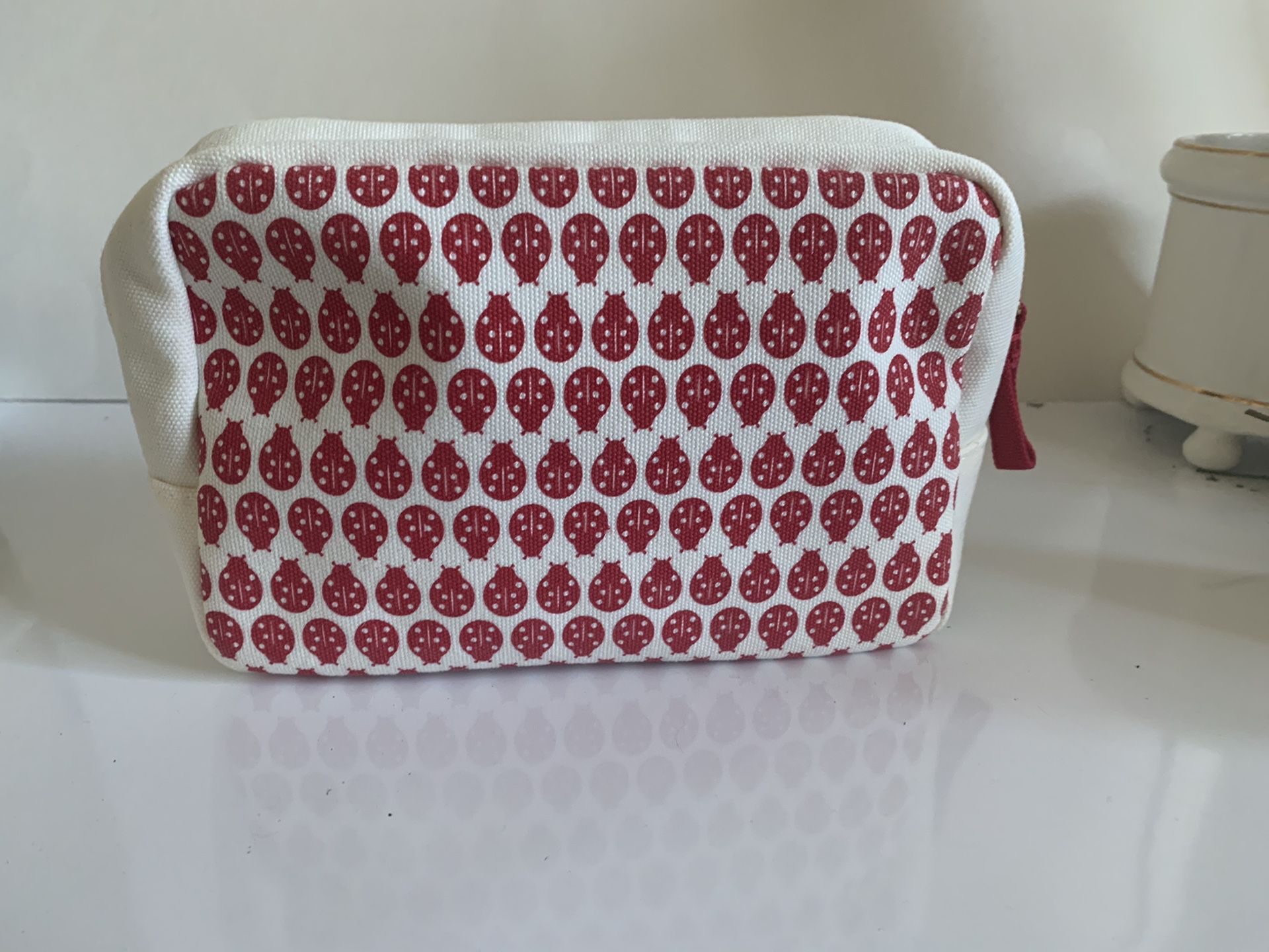 Clarins Paris Fabric Lady Bug Makeup Bag. 8 inches wide, 5 inches tall, 3 inches width. Ivory with red ( lady bags) and black accents, red zipper. 💯