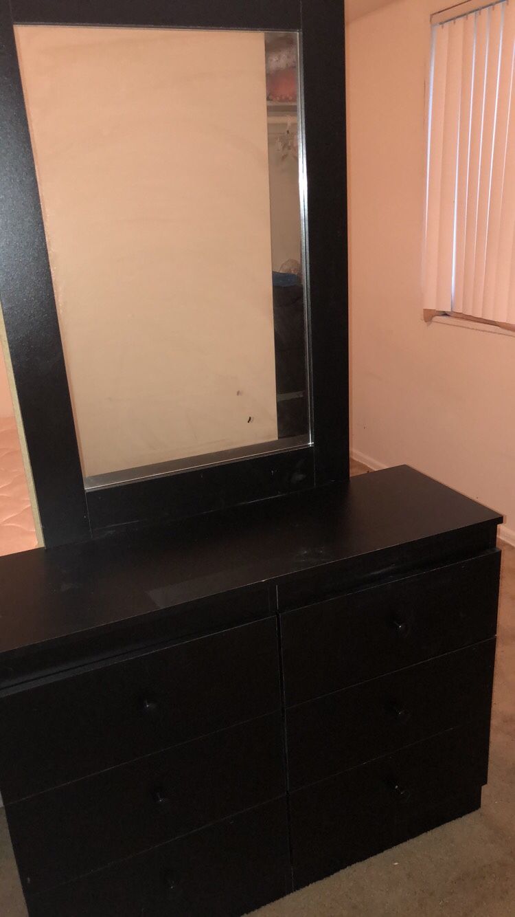 Black wooden dresser with mirror