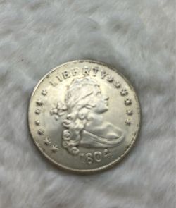 Selling a replica (not real) 1804 Draped Bust silver dollar coin. Great as a display piece, teaching aid, or for collectors of replica coins.  This is