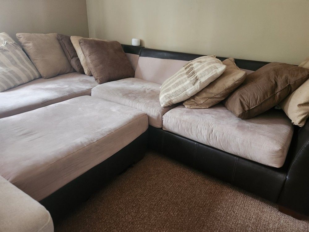 L shaped TAN SOFA WITH OTTOMAN with pillows