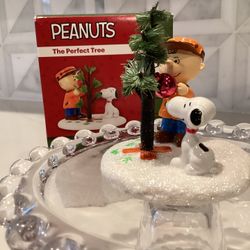 Peanuts figurine featuring a character with a tree and Snoopy. Department 56 2.8”T (new in box)