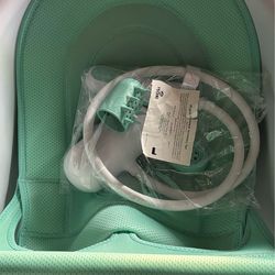 Frida, baby bath and showerhead attachment